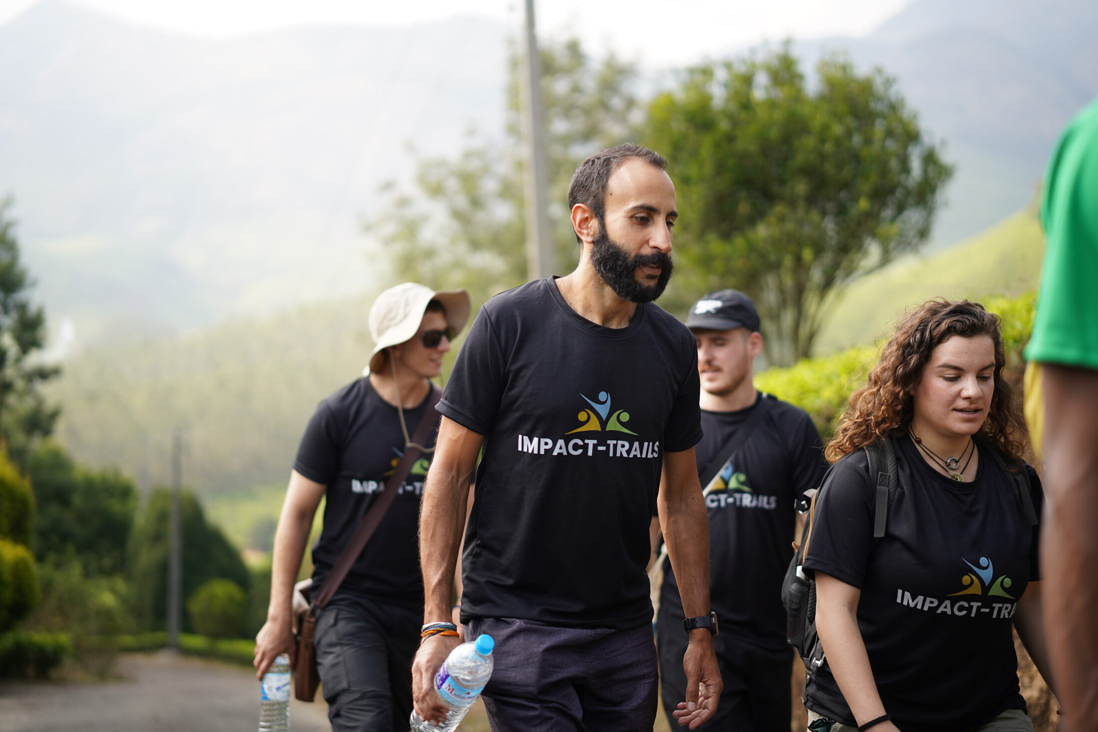 Impact-Trails participants trekking together in team shirts
